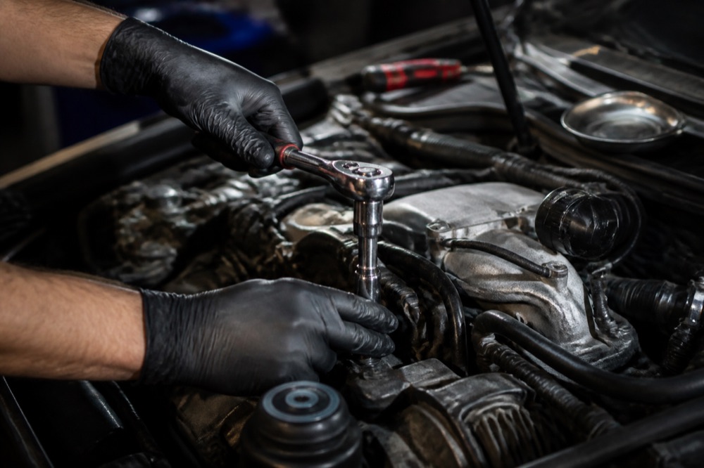 Mechanic using a ratchet during an engine repair