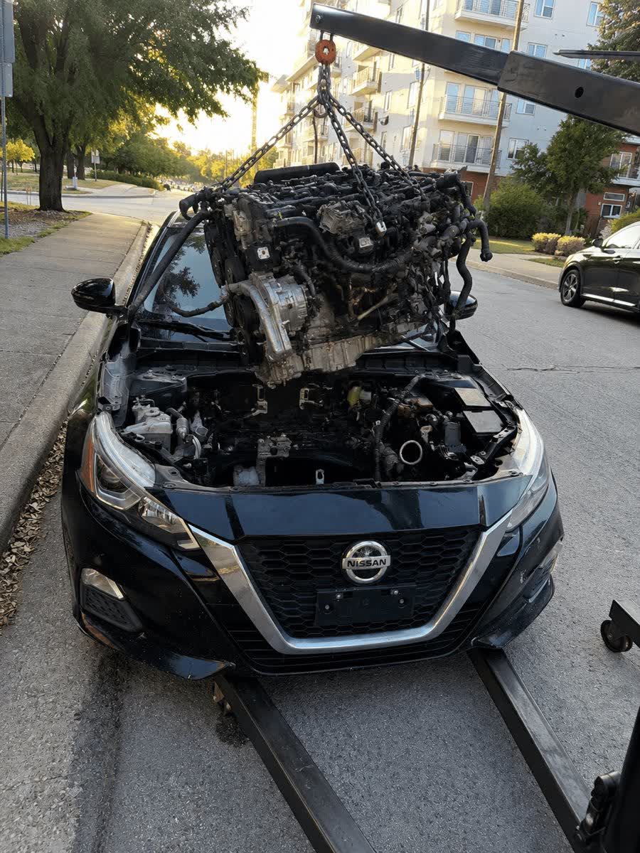 Engine being removed from a Nissan at Ismaili Company