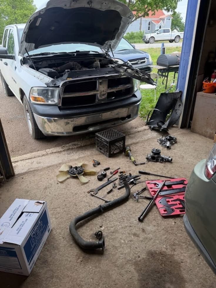 Pickup truck with the front end apart and cooling-system parts laid out